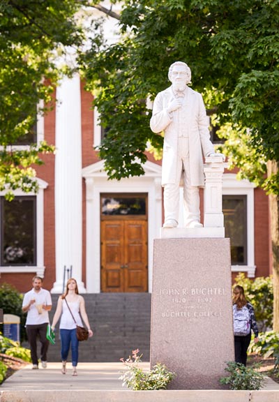 A statue of University founder John Buchtel stands before Buchtel Hall