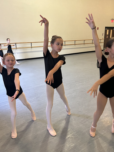 Young ballet students in mid-movement