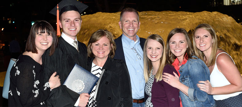 Family of UA college graduate in a group photo at commencement ceremony
