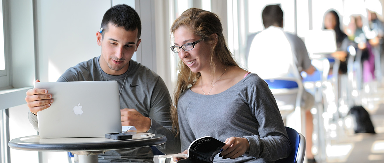 male-female-students-looking-at-a-laptop.jpg