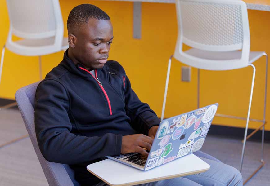 Student working on his laptop