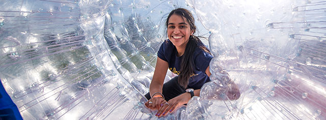 A student in a giant  hamster ball at SpringFest