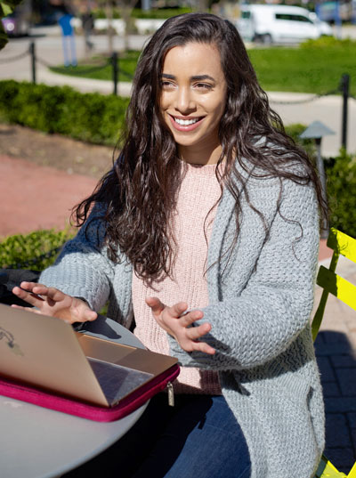A student studying outside on the University of Akron campus