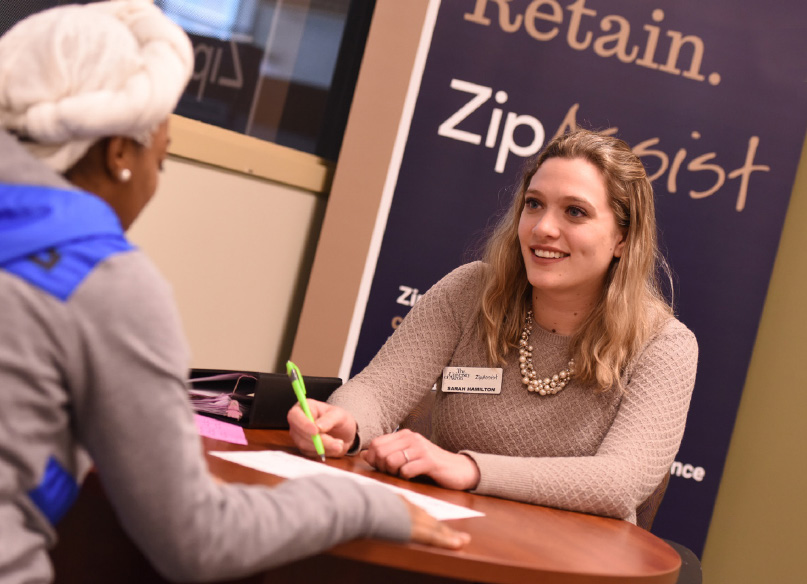 Sarah Hamilton helps a University of Akron student seeking support from ZipAssist