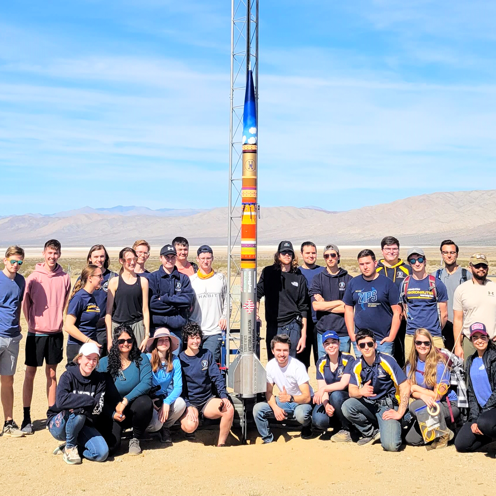 Akronauts team members in the Mojave Desert with their Emergence II rocket.
