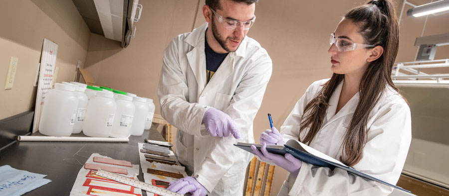 Two corrosion engineers work in a lab at The University of Akron