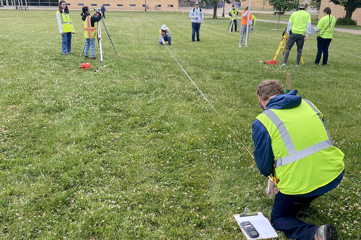 The surveying team runs a cut/fill analysis for a sewer line as part of the field tasks at the competition.