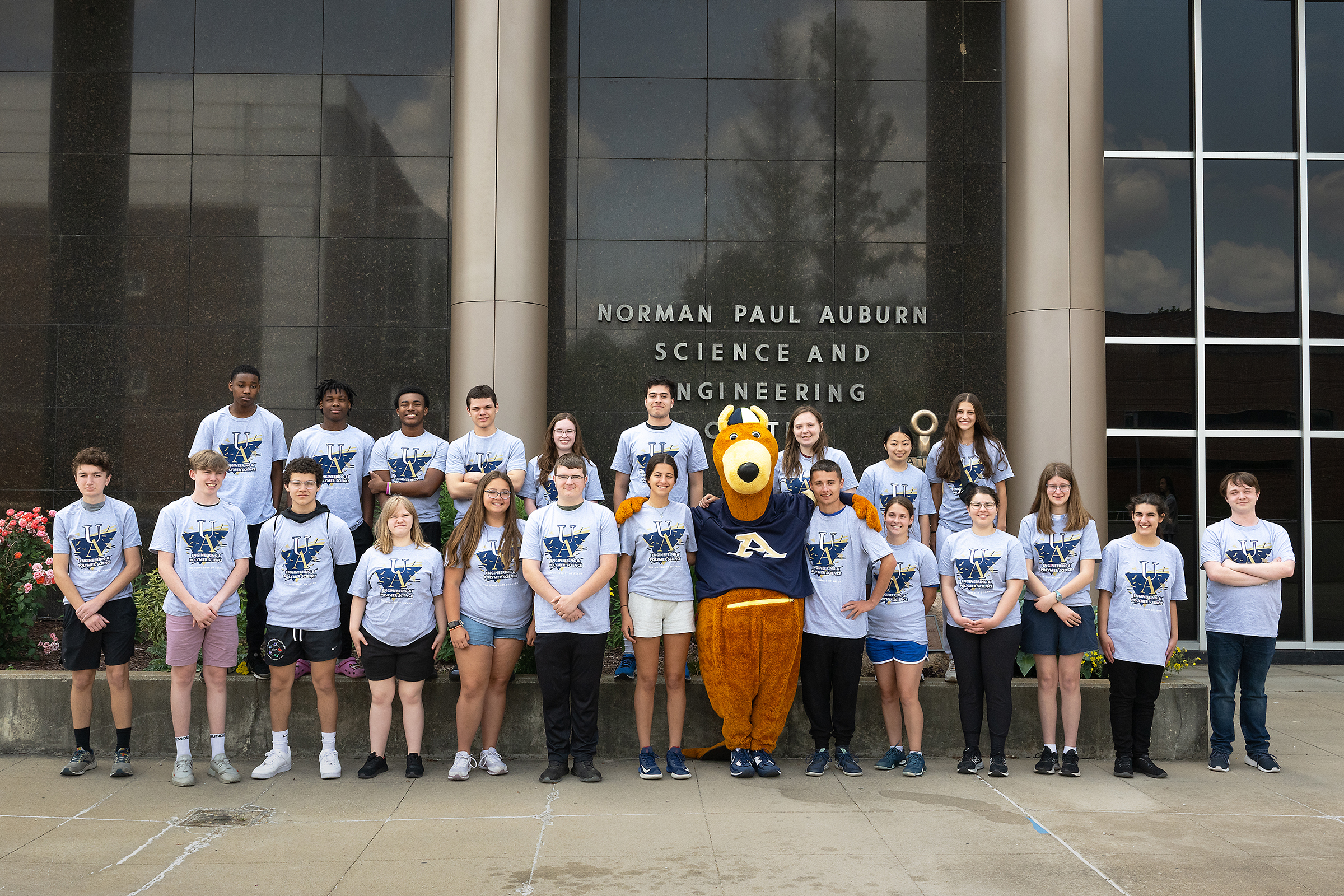 Summer Experience in Engineering campers pose with Zippy in front of the Auburn Science and Engineering Center.