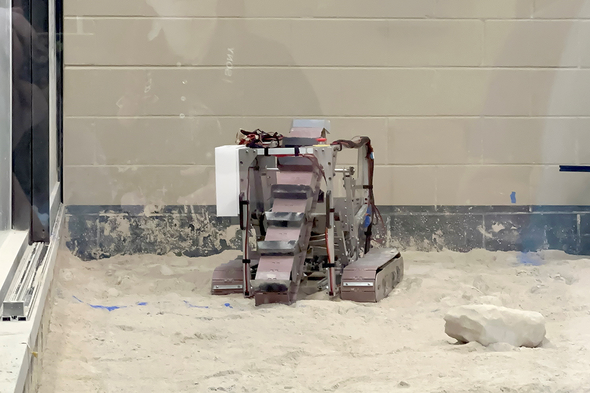 The team’s robot tries to move and collect regolith in a competition round.