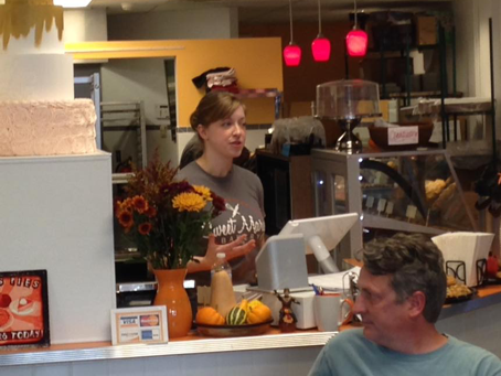 Mary Hospodarsky, owner of Sweet Mary’s Bakery, speaking with students and community members at her downtown Akron restaurant (also pictured, Kyle Julien of the East Akron Neighborhood Development Corporation).