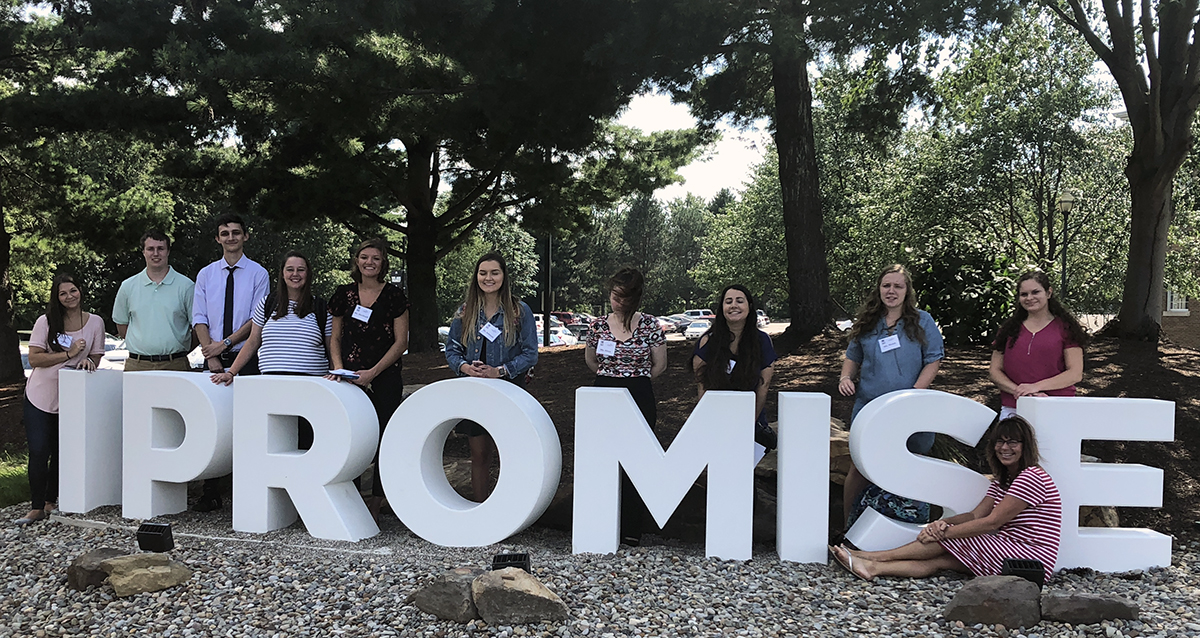 UA students with I-Promise sign