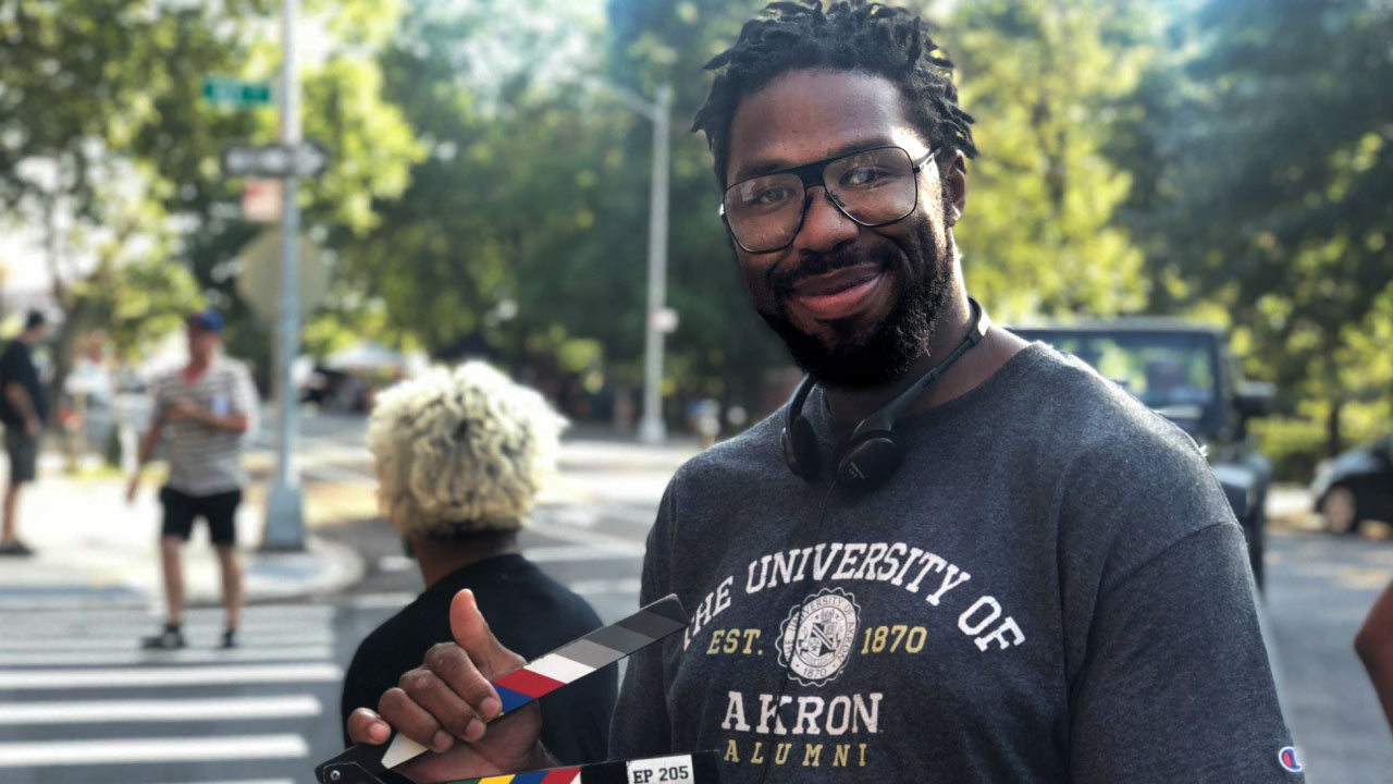 Matthew Cherry on set wearing a UA T-shirt