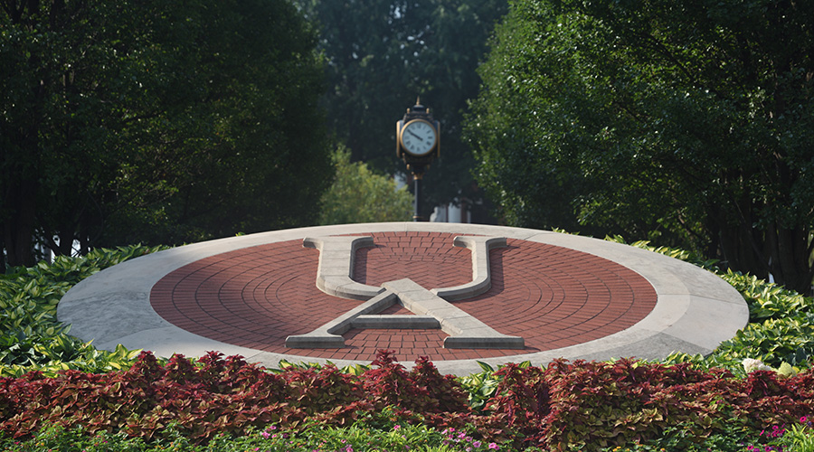 A decorative UA in stone near the campus center.