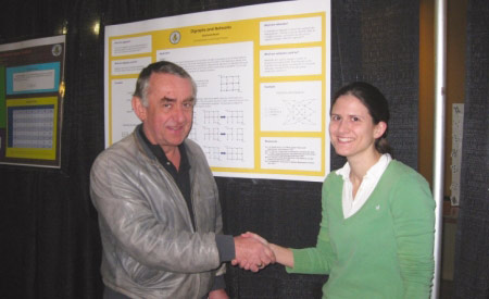 A mathematics faculty member and a student at a math conference.