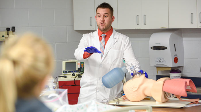 A faculty member leads nursing students in a lab at The University of Akron