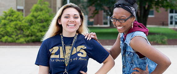 Two Akron Rises Scholars enjoy a laugh on campus between classes