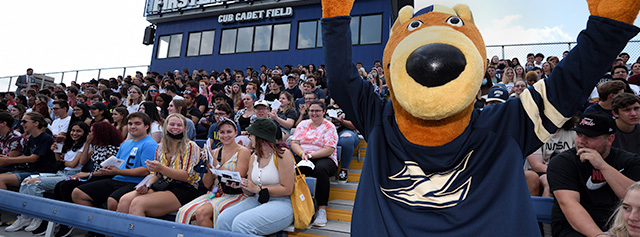 Zippy and students cheering on the men's soccer team.