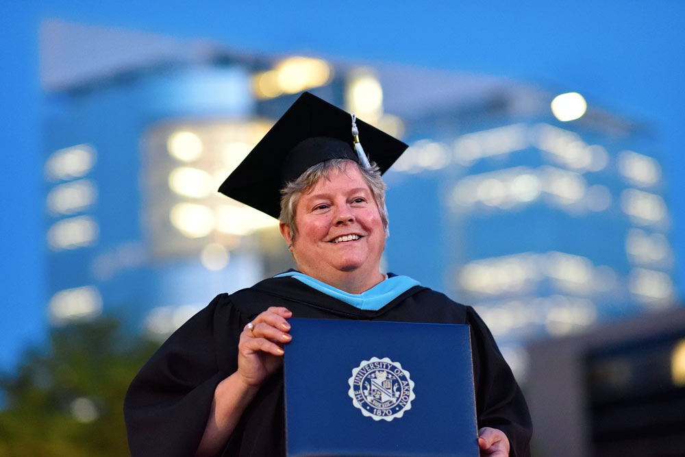 An adult student at commencement on The University of Akron campus